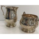 A George VI silver baluster cream jug and matching sugar basin by Charles Boyton & Sons of