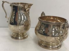 A George VI silver baluster cream jug and matching sugar basin by Charles Boyton & Sons of