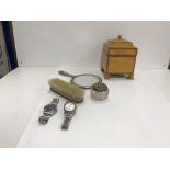 A box containing a small hand mirror, brush and white metal mounted dressing table pot,