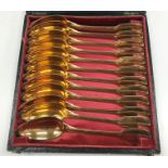 A set of twelve 19th Century Continental silver gilt “Fiddle and Thread” pattern grapefruit spoons,