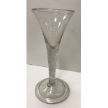 An 18th Century wine glass of trumpet form with air twist stem on a circular folded foot 14.