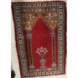 A Bokhara rug the central panel set with Mirhab style design on a red ground within a stepped red,