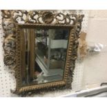 A 19th Century carved giltwood and gesso framed wall mirror with shell and scrolling foliate