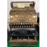 A late Victorian brass cased National cash register (LSD) with all over scrolling foliate and