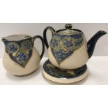 A Moorcoft MacIntyre three piece tea set with mottled ground decorated with flower head medallions