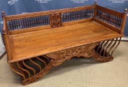 A 20th Century Malaysian teak howdah with railed and turned decoration and carved foliate front