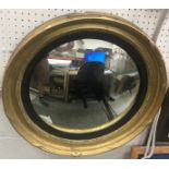 A 19th Century giltwood and gesso framed convex wall mirror with ebonised reeded slip,