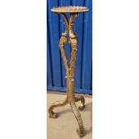 A carved giltwood and gesso framed torchere in the Continental Rococo taste,