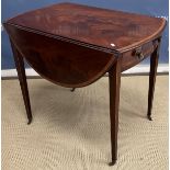 An early 19th Century mahogany Pembroke table, the figured oval drop-leaf top cross-banded,