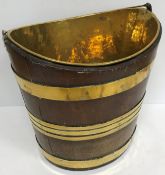 A 19th Century mahogany and brass bound navette form bucket with brass liner and narrow swing