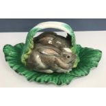 A Portuguese majolica ware tureen and cover as two rabbits amongst lettuce leaves 45 cm long x 20