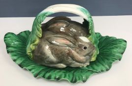 A Portuguese majolica ware tureen and cover as two rabbits amongst lettuce leaves 45 cm long x 20