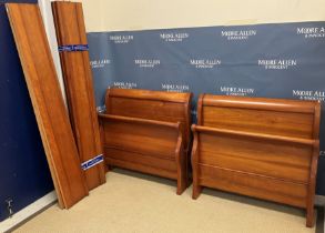 A pair of modern cherrywood single sleigh beds in the Louis-Philippe taste,