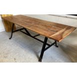 A modern American pine and black walnut plank top table on angle iron trestle end supports united