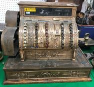 A late 19th Century American National brass cased cash register (dollars/cents) with all over