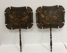A pair of 19th Century Chinese black lacquered and "chinoiserie" decorated face screens,