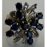 A 1940s 18 carat white gold sapphire and diamond floral spray dress ring,