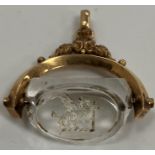 A 19th Century yellow metal mounted rock crystal seal decorated to one side with dragon and axe,