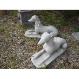 A pair of composite stone recumbent greyhounds 65 cm long x 38 cm high