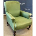 A Victorian upholstered scroll arm chair on turned and reeded front legs to brass caps and castors,