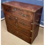 A teak and brass bound military style campaign chest in the 19th Century manner in two sections,