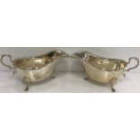 A pair of George V silver sauceboats in the 18th Century style with shell and scroll work decorated