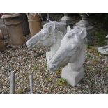 A pair of composite stone horse heads on square bases 62 cm high x 58 cm deep