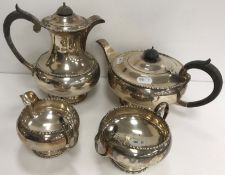 A George V silver four-piece tea set of bellied form, with beaded decoration (by Walker & Hall,