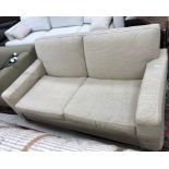 A modern fawn corduroy type upholstered two seat sofa on heavy square tapered supports,