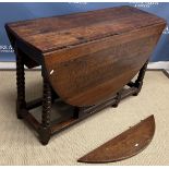 An oak gate leg drop leaf dining table in the 17th Century manner on bobbin turned supports 151 cm