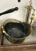 A late Victorian brass helmet shaped coal scuttle and an early 20th Century brass fireside