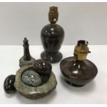 A collection of serpentine items including two small table lamps,