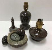 A collection of serpentine items including two small table lamps,