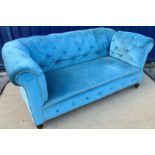 A circa 1900 turquoise buttoned upholstered scroll arm Chesterfield type drop arm sofa on turned