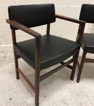 A set of six 1970s rosewood framed dining chairs with upholstered back panels and seats in black,