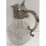 A late Victorian cut glass claret jug of onion form with silver mounts (by William Gibson and John