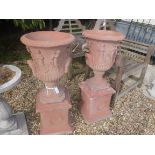 A pair of modern terracotta urns in the Classical taste 95 cm high