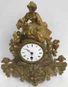 A 19th Century French gilt metal cased mantel clock with figural surmount,