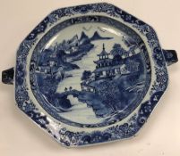 A 19th Century Chinese blue and white warmer plate of octagonal form with lug handles (one for