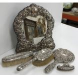 An embossed silver framed cherub decorated easel dressing mirror 28 cm high,