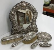 An embossed silver framed cherub decorated easel dressing mirror 28 cm high,