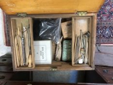 An artist's box and contents of various palette knives,