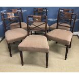 A set of six Regency mahogany X back dining chairs with upholstered seats on turned and reeded