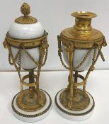 A pair of 19th Century gilt bronze mounted porcelain cassolettes in the Louis XVI taste 24 cm high