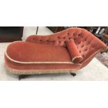 An early to mid 20th Century buttoned upholstered chaise longue on sabre supports in the Regency