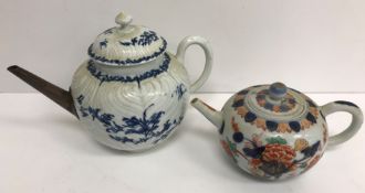 An 18th Century Worcester floral spray and feather moulded bullet shaped teapot with replacement