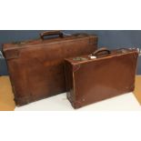 A leather suitcase together with a further suitcase initialled "ANS"