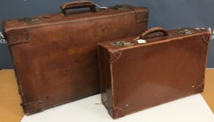 A leather suitcase together with a further suitcase initialled "ANS"