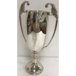 A George V silver trophy cup with acanthus decorated open work handles,