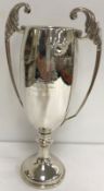 A George V silver trophy cup with acanthus decorated open work handles,